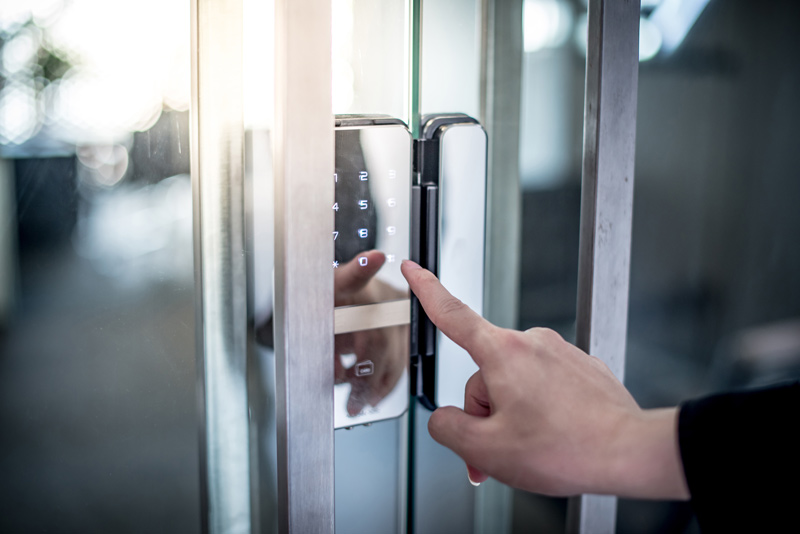 Businessman hand pressing down password number on electronic acc